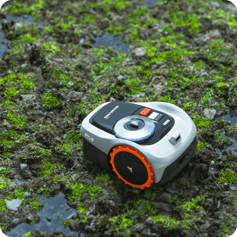 Navimow i105E robot lawn mower on the wet mossy ground.