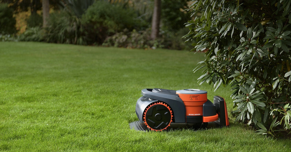 Navimow i110N robot lawn mower sits on the green lawn.