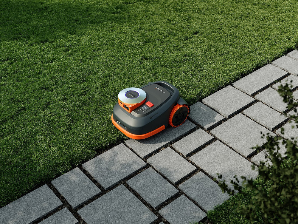 Segway Navimow i110N robot lawn mower on grass next path.