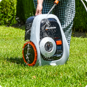 Navimow i110E robot lawn mower being washed with a hose.