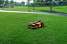 Segway Navimow i105E robot lawn mower on a green lawn.