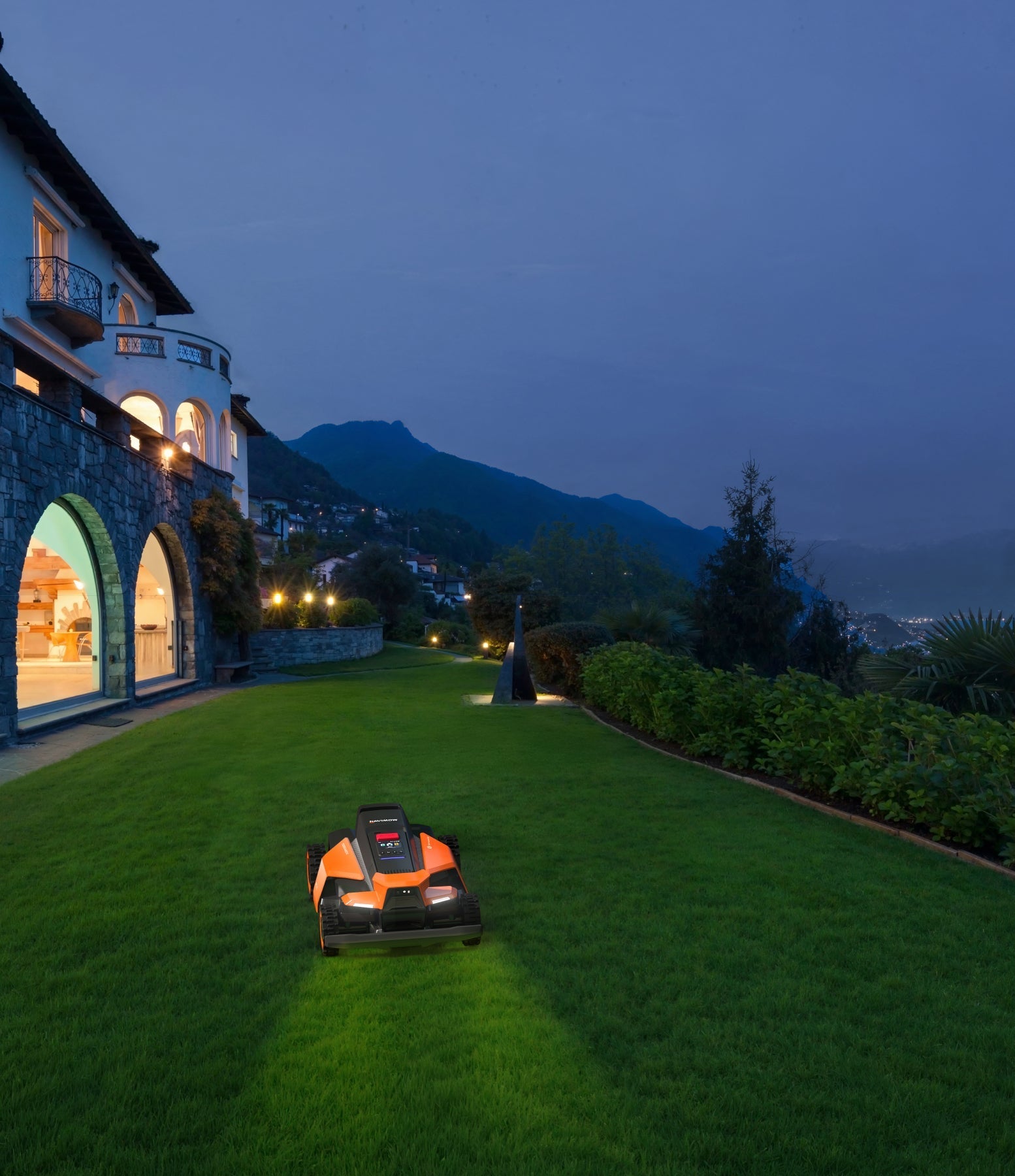 Navimow i110N robot lawn mower mows grass on green lawn.