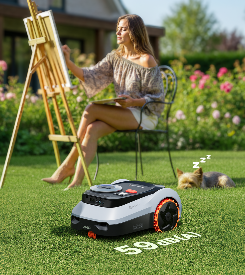 Segway Navimow robot lawn mower mows while a woman paints.