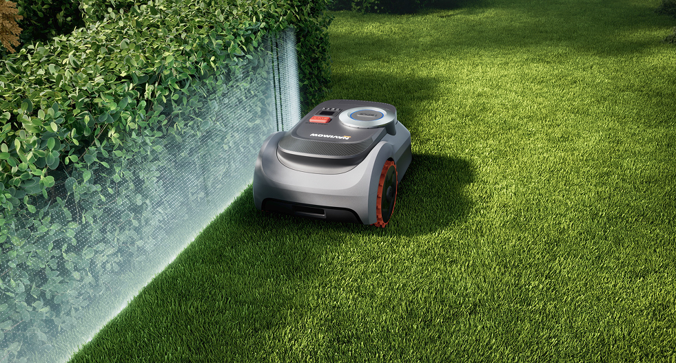The Navimow i105E robot lawn mower mows the green lawn.